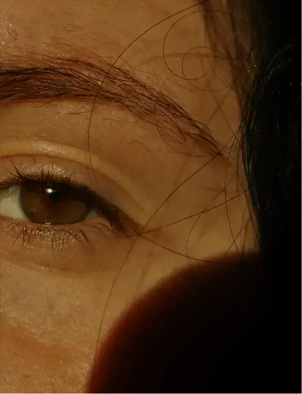 Close-up portrait of a person's eye and face